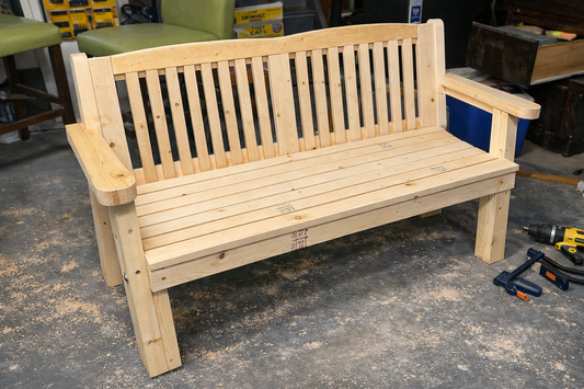 Partially built wooden bench in workshop showing frame and leg structure