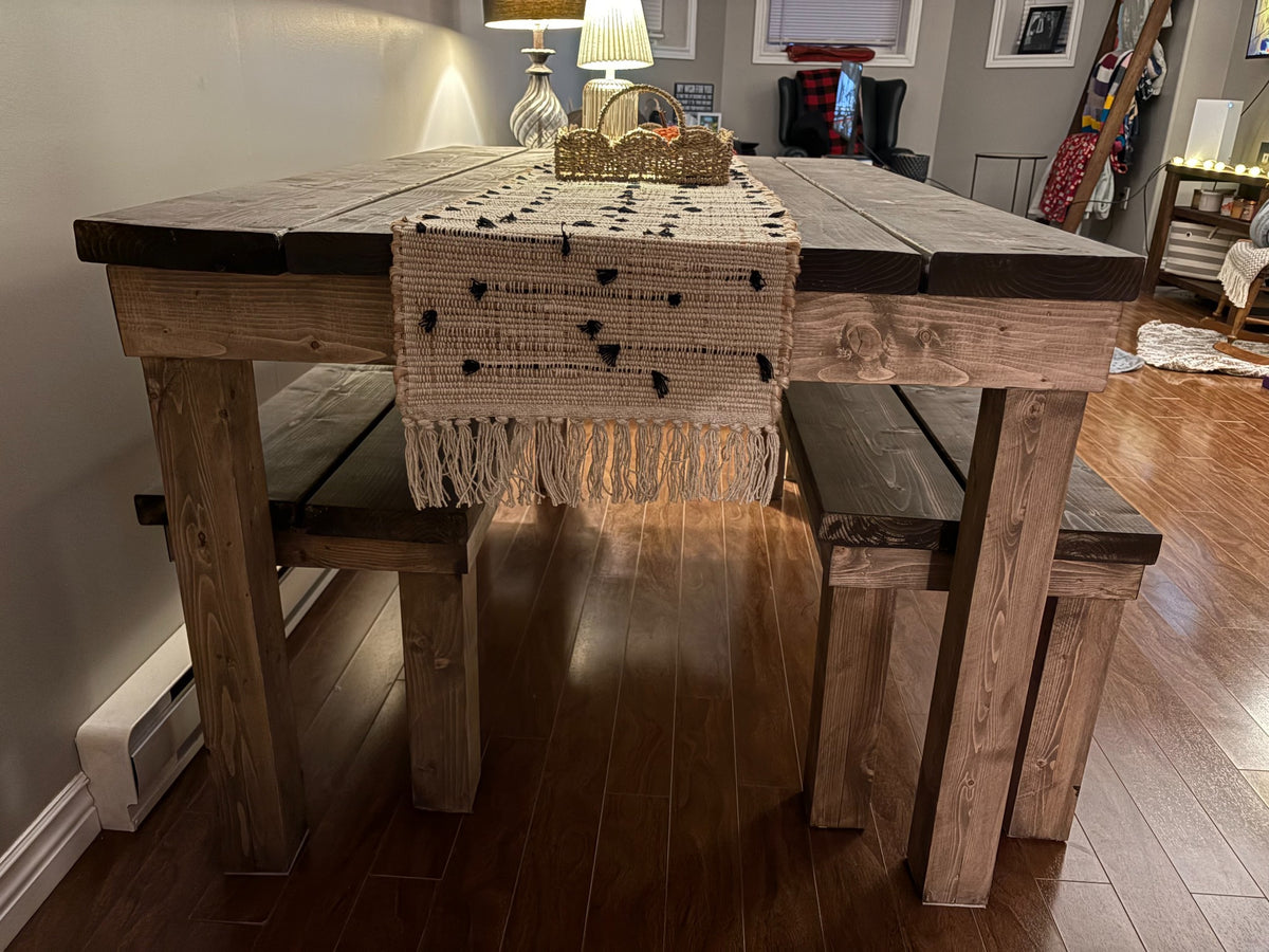 Finished wooden table and bench set showing the benches stored underneath the table