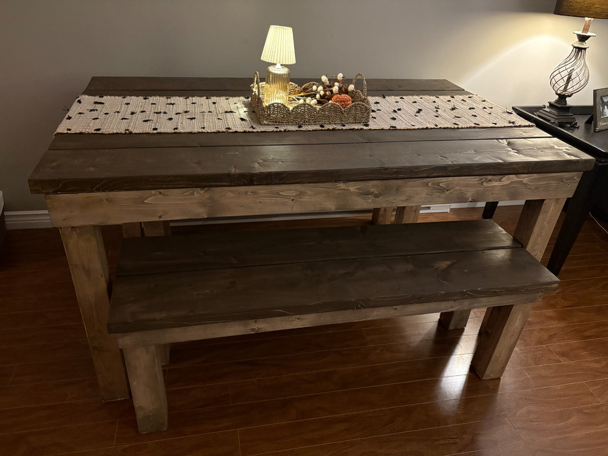 Finished wooden table and bench set viewed from the side with one bench pulled out