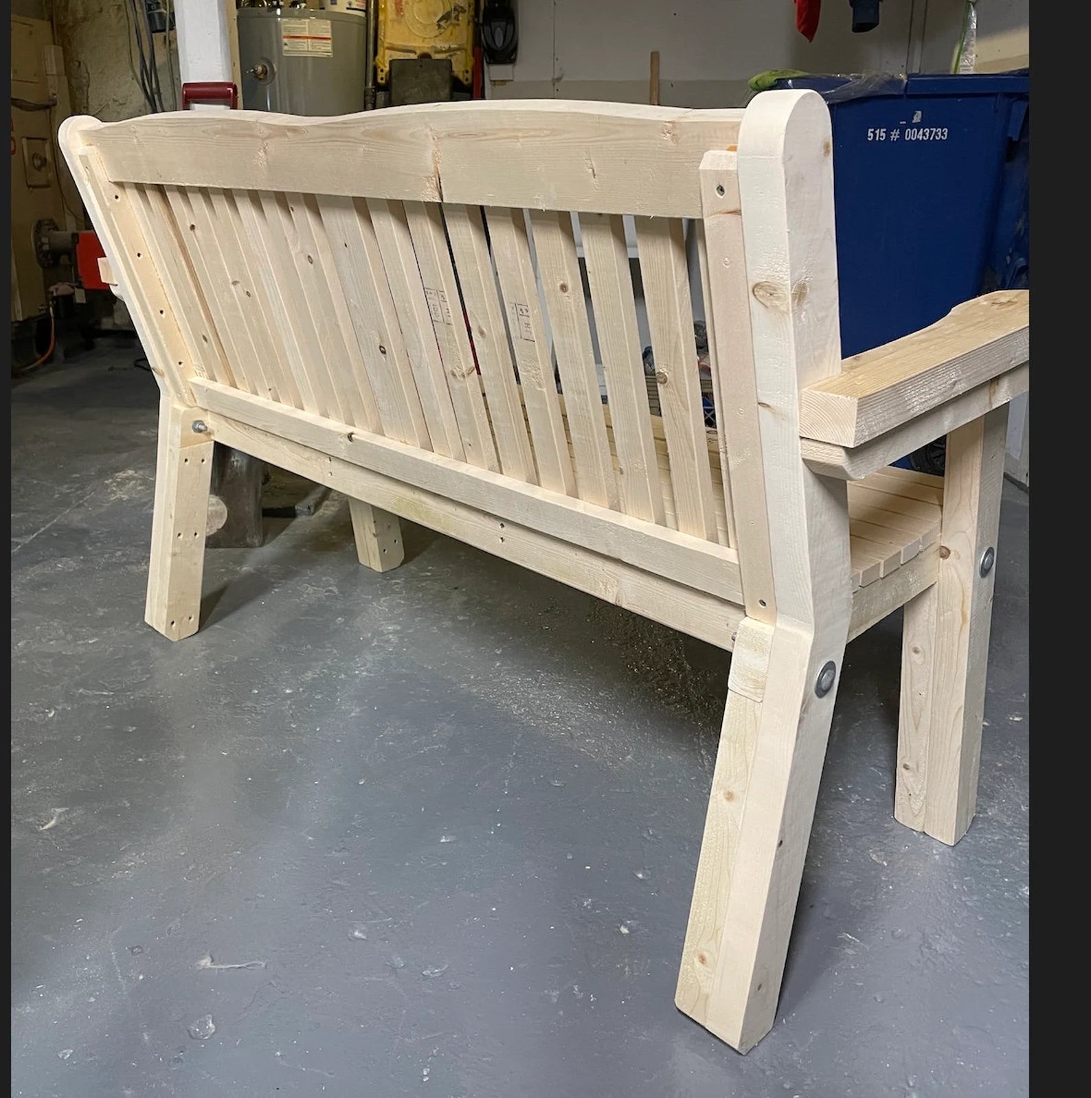 Back view of DIY outdoor bench showing slatted back support and sturdy wood frame construction